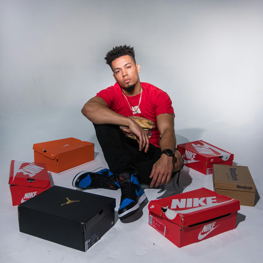 model red tshirt with shoe boxes around him such as nike and jordan. Image used in friendly business blog, for the Seacret